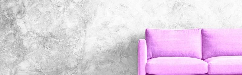 Purple couch grey wall